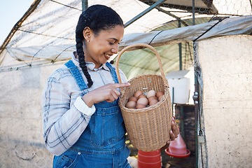 Image showing Happy woman checking eggs in basket at farm chicken coop, inspection and countryside greenhouse at sustainable business. Agriculture, poultry and girl farmer with smile, pride for food and counting.