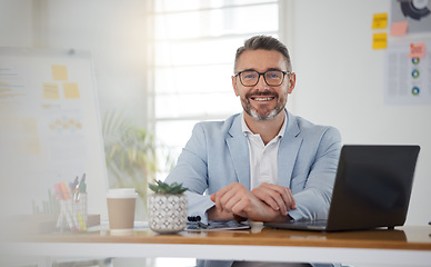 Image showing Portrait of businessman at office desk with smile, laptop and tablet on business website, online report or social media. Internet, digital app and confident, mature man with workshop and web schedule