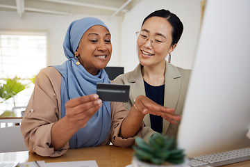 Image showing Online shopping, credit card and business women or friends doing ecommerce or banking while talking together. Muslim, asian and professional consulting a customer on rewards purchase on website