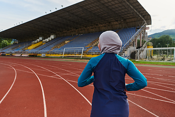 Image showing A muslim woman in a burqa sports muslim clothes running on a marathon course and preparing for upcoming competitions