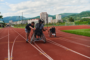 Image showing A cameraman filming the participants of the Paralympic race on the marathon course