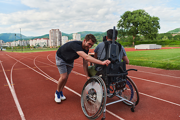 Image showing A cameraman filming the participants of the Paralympic race on the marathon course