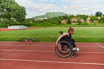 Image showing A woman with disablity driving a wheelchair on a track while preparing for the Paralympic Games