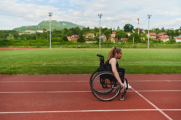 Image showing A woman with disablity driving a wheelchair on a track while preparing for the Paralympic Games