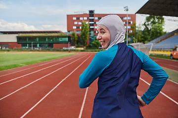 Image showing A muslim woman in a burqa sports muslim clothes running on a marathon course and preparing for upcoming competitions