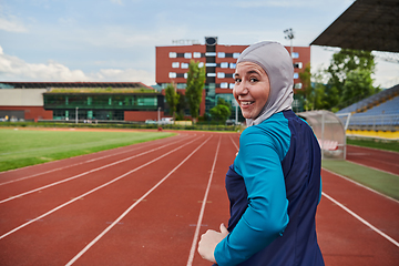 Image showing A muslim woman in a burqa sports muslim clothes running on a marathon course and preparing for upcoming competitions