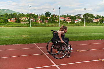 Image showing A woman with disablity driving a wheelchair on a track while preparing for the Paralympic Games