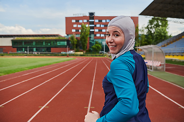 Image showing A muslim woman in a burqa sports muslim clothes running on a marathon course and preparing for upcoming competitions