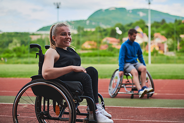 Image showing A woman with disablity driving a wheelchair on a track while preparing for the Paralympic Games