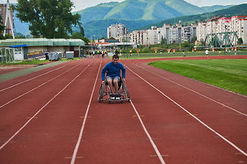 Image showing A person with disability in a wheelchair training tirelessly on the track in preparation for the Paralympic Games