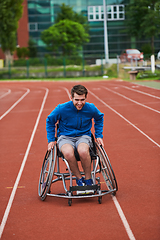 Image showing A person with disability in a wheelchair training tirelessly on the track in preparation for the Paralympic Games