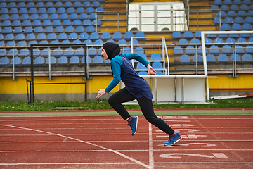 Image showing A muslim woman in a burqa sports muslim clothes running on a marathon course and preparing for upcoming competitions