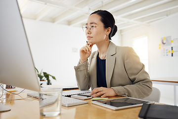 Image showing Business woman, computer and thinking, planning or problem solving for marketing, website design or project. Professional asian person with focus, decision or choice on desktop for creative solution