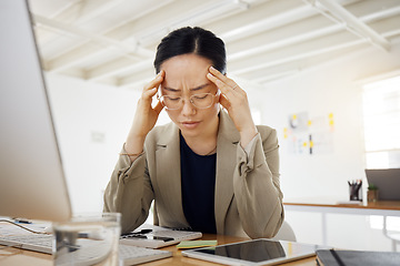 Image showing Headache, stress and asian woman in office with problem, mistake or frustrated by computer, bankruptcy or deadline. Anxiety, migraine and Japanese person with brain fog or vertigo in audit or crisis