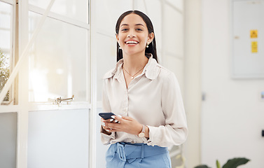 Image showing Happy woman, portrait and typing on smartphone in office for social media, networking and mobile contact in Colombia. Business worker scroll on cellphone tech, digital information and smile at window