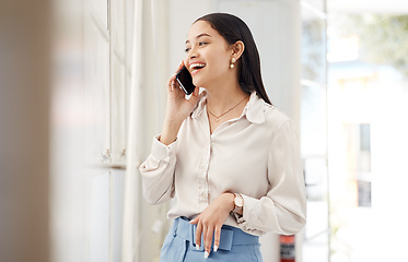 Image showing Business woman, laugh and phone call for conversation, feedback and mobile chat in office. Happy employee talking on smartphone for contact, consulting and thinking of funny communication at window