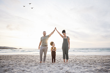 Image showing Family, high five and beach for travel, celebration and freedom, bond or fun in nature together. Love, hands together and girl child with parents at sea playing, relax and happy on holiday in Bali