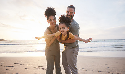 Image showing Family, portrait and beach for airplane, travel and freedom, bond and fun in nature together. Love, flying and happy girl child with parents at the ocean playing, relax and smile on summer holiday