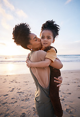 Image showing Beach, sunset and mother kissing her child on a family vacation, holiday or travel adventure. Love, care and mom holding, hugging and bonding with her girl kid by the ocean on weekend trip in Mexico.