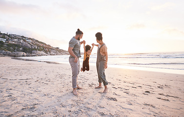 Image showing Sunset, swing and holding hands with family at beach for bonding, summer vacation and travel. Smile, happy and relax with parents and child walking on seaside holiday for love, freedom and support