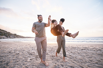 Image showing Happy, swing and holding hands with family at beach for bonding, summer vacation and travel. Smile, sunset and relax with parents and child walking on seaside holiday for love, freedom and support