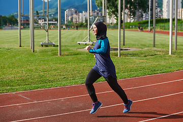 Image showing A muslim woman in a burqa sports muslim clothes running on a marathon course and preparing for upcoming competitions