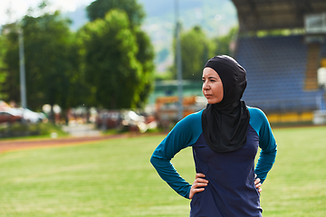 Image showing A Muslim woman with a burqa, an Islamic sportswoman resting after a vigorous training session on the marathon course. A hijab woman is preparing for a marathon competition