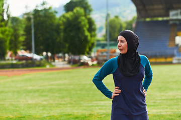 Image showing A Muslim woman with a burqa, an Islamic sportswoman resting after a vigorous training session on the marathon course. A hijab woman is preparing for a marathon competition