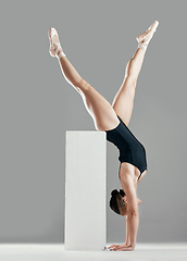 Image showing Balance, ballet or woman in studio on a handstand, block or platform for elegant routine or creative freedom. Flexible, dancer or girl ballerina dancing or training to exercise on white background