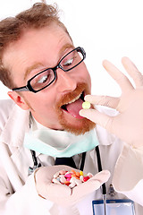 Image showing doctor taking hand full of tablets 