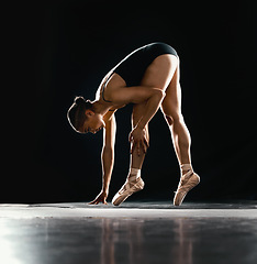 Image showing Ballet, woman or dancer with training, talent or performance on a dark studio background. Female performer, ballerina or artist with technique, prepare for a show and creative with fitness and pose