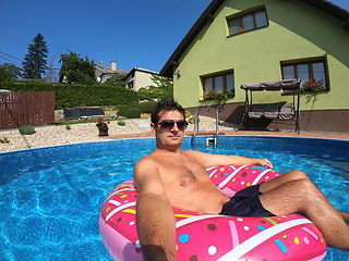 Image showing Happy man relax on inflatable ring. Holiday 2020