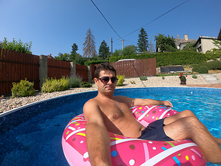 Image showing Happy man relax on inflatable ring. Holiday 2020