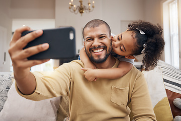 Image showing Father, girl and selfie kiss in home living room, bonding and having fun together. Dad, child and hug in profile picture, happy memory and smile on social media post of family on sofa, love and care