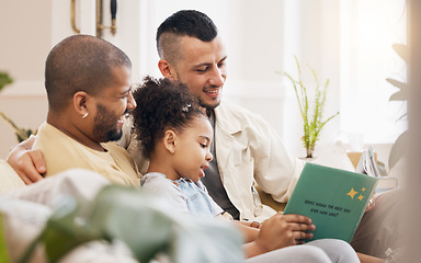 Image showing Gay couple, child and book on sofa with smile, bonding and love in storytelling in living room together. Happiness, lgbt men and girl reading story on couch in fantasy, learning and education in home