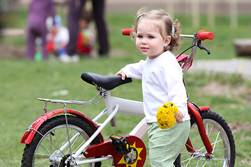 Image showing girl with flower and bicycle