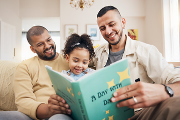 Image showing Gay couple, kid and book on couch with smile, bonding and love in storytelling in living room together. Happiness, lgbt men and girl reading story on sofa for fantasy, learning and education in home.