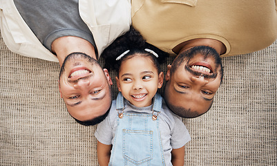 Image showing Gay dad, blended family and adoption with a girl lying together on the floor of the home for love from above. LGBT smile, children or kids and a daughter bonding with her happy parents in the house