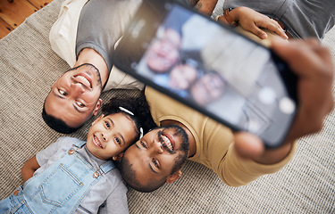 Image showing Selfie, gay father and blended family with a girl lying together on the floor of the home for a picture from above. LGBT love, children or kids and a daughter with her happy parents for a photograph