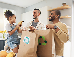 Image showing Shopping, bags and happy family with groceries in home and girl with fruit and gay parents, dad and father in kitchen. Sustainable, paper bag and people with eco friendly grocery, product or fruits