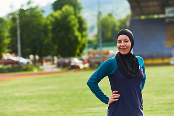 Image showing A Muslim woman with a burqa, an Islamic sportswoman resting after a vigorous training session on the marathon course. A hijab woman is preparing for a marathon competition