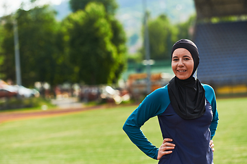 Image showing A Muslim woman with a burqa, an Islamic sportswoman resting after a vigorous training session on the marathon course. A hijab woman is preparing for a marathon competition