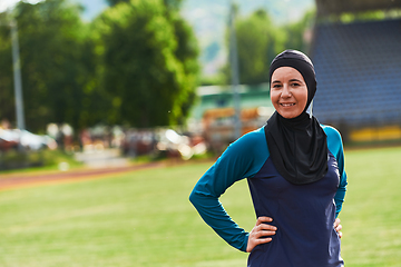 Image showing A Muslim woman with a burqa, an Islamic sportswoman resting after a vigorous training session on the marathon course. A hijab woman is preparing for a marathon competition