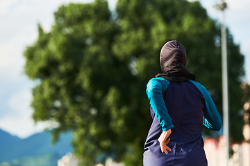 Image showing A muslim woman in a burqa sports muslim clothes running on a marathon course and preparing for upcoming competitions