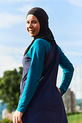 Image showing A Muslim woman with a burqa, an Islamic sportswoman resting after a vigorous training session on the marathon course. A hijab woman is preparing for a marathon competition