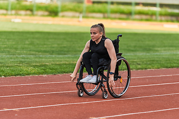 Image showing A woman with disablity driving a wheelchair on a track while preparing for the Paralympic Games