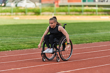 Image showing A woman with disablity driving a wheelchair on a track while preparing for the Paralympic Games