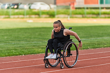 Image showing A woman with disablity driving a wheelchair on a track while preparing for the Paralympic Games