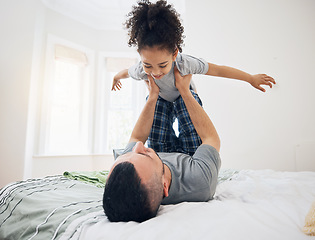 Image showing Happy, fun and dad with child on bed playing, bonding and airplane game for father and daughter in home. Family, love and playful energy, man holding girl in air and laughing in bedroom together.