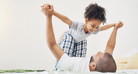 Image showing Home, father and daughter on a bed for airplane game, bonding and happiness in morning. Excited girl child and man or parent together in a family bedroom for fun, playing and support for lift in air